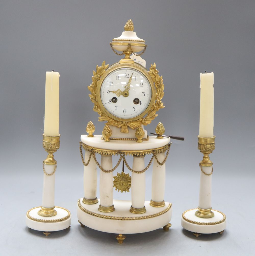 A French Louis XVI style white marble and ormolu four pillar clock garniture, height 35cm